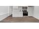 Finished basement kitchenette with white cabinets and stainless appliances at 552 Steels Bridge Rd, Canton, GA 30114