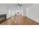 Open-concept living room with hardwood flooring, a fireplace, and access to the kitchen, great for entertaining at 552 Steels Bridge Rd, Canton, GA 30114