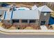 Aerial view of a community pool with brick building and a tin roof with street access and landscaping at 6775 Pippin Walk, Alpharetta, GA 30005