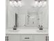 This bright bathroom features double sinks, granite counters, shaker cabinets, and chrome fixtures at 6775 Pippin Walk, Alpharetta, GA 30005
