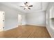 An airy bedroom features tray ceilings, warm wood floors, neutral wall colors and lots of natural light at 6775 Pippin Walk, Alpharetta, GA 30005