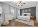 Large main bedroom showcasing hardwood floors, tray ceiling, and abundant natural light from windows at 6775 Pippin Walk, Alpharetta, GA 30005