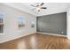 Light-filled bedroom showcasing tray ceilings, hardwood flooring, and ample natural light at 6775 Pippin Walk, Alpharetta, GA 30005