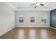 Spacious bedroom with tray ceilings, large windows, and hardwood flooring at 6775 Pippin Walk, Alpharetta, GA 30005
