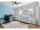 Well-lit bedroom with light blue accent wall, neutral furnishings, and stylish decor at 6775 Pippin Walk, Alpharetta, GA 30005