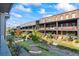 Beautiful brick townhomes with patios, landscaped grounds, and blue skies above create a welcoming community at 6775 Pippin Walk, Alpharetta, GA 30005
