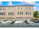 New construction townhomes feature brick facade, covered garages, with neutral paint to enhance curb appeal at 6775 Pippin Walk, Alpharetta, GA 30005
