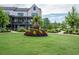 Well-manicured community greenspace features mature trees, flower beds, walkways, and manicured lawns at 6775 Pippin Walk, Alpharetta, GA 30005