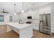 Well-lit kitchen with white cabinets, stainless steel appliances, and a generous island for cooking and entertaining at 6775 Pippin Walk, Alpharetta, GA 30005