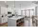 Bright kitchen showcases white cabinets, stainless appliances, a central island with seating, and stylish pendant lights at 6775 Pippin Walk, Alpharetta, GA 30005