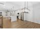 Open-concept kitchen boasts a large island, stainless steel appliances, and seamlessly connects to the living and dining areas at 6775 Pippin Walk, Alpharetta, GA 30005