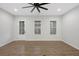 Bright living room with beautiful hardwood floors, door, natural light, windows and ceiling fan at 6775 Pippin Walk, Alpharetta, GA 30005