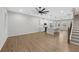 Bright and airy living space open to the kitchen, featuring hardwood floors and modern fixtures at 6775 Pippin Walk, Alpharetta, GA 30005