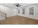 Modern living area featuring beautiful hardwood floors, white walls, natural light, and ceiling fan at 6775 Pippin Walk, Alpharetta, GA 30005