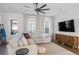 Bright living room featuring a large sectional sofa, wood cabinet, and stylish decor at 6775 Pippin Walk, Alpharetta, GA 30005