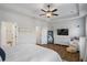 Spacious main bedroom featuring a tray ceiling, ceiling fan, and ample room for relaxation at 6775 Pippin Walk, Alpharetta, GA 30005