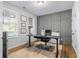 Well-lit home office with modern furniture, paneled accent wall, and functional workspace at 6775 Pippin Walk, Alpharetta, GA 30005