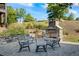 Community outdoor space with stone fireplace, stone walls, manicured landscaping, and patio seating at 6775 Pippin Walk, Alpharetta, GA 30005