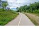 Community walking path along green space with native landscape and residential buildings at 6775 Pippin Walk, Alpharetta, GA 30005