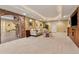 Finished basement with carpeted floor, recessed lights, brick accents, and a seating area with a white sofa at 2551 Raintree Ne Dr, Atlanta, GA 30345