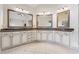 Elegant bathroom featuring dual vanities with granite countertops and tile flooring at 2551 Raintree Ne Dr, Atlanta, GA 30345