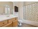 Bathroom featuring a robot-themed shower curtain, cabinet, and light tile floor at 2551 Raintree Ne Dr, Atlanta, GA 30345