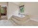 Well-lit bathroom featuring large soaking tub and big window with custom privacy blinds at 2551 Raintree Ne Dr, Atlanta, GA 30345