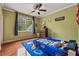 Bedroom with a race car themed bed, ceiling fan, hardwood floors and a window at 2551 Raintree Ne Dr, Atlanta, GA 30345