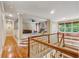 A large bonus room featuring hardwood floors, a sitting bench, and a ceiling fan at 2551 Raintree Ne Dr, Atlanta, GA 30345