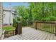 Wooden deck overlooking landscaped backyard, with black metal railing and multiple levels at 2551 Raintree Ne Dr, Atlanta, GA 30345