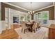 Spacious dining room with hardwood floors, chandelier, and views into an adjacent living area at 2551 Raintree Ne Dr, Atlanta, GA 30345