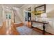 Elegant foyer featuring hardwood floors, a staircase, and stylish decor with natural light at 2551 Raintree Ne Dr, Atlanta, GA 30345