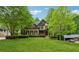 Inviting home with a verdant lawn, mature trees, and traditional architectural details at 2551 Raintree Ne Dr, Atlanta, GA 30345