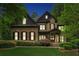 Elegant home exterior featuring manicured landscaping, and illuminated windows at twilight at 2551 Raintree Ne Dr, Atlanta, GA 30345