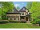 Charming brick home featuring lush landscaping, a well-manicured lawn, and a welcoming front porch at 2551 Raintree Ne Dr, Atlanta, GA 30345