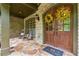 Cozy front porch with rocking chairs, stone flooring, and a welcoming double-door entrance at 2551 Raintree Ne Dr, Atlanta, GA 30345