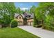 Spacious garage with a multi-car driveway, and professional landscaping, offering ample parking at 2551 Raintree Ne Dr, Atlanta, GA 30345