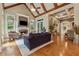 Inviting living room showcasing beamed ceilings, hardwood floors, and a stone fireplace at 2551 Raintree Ne Dr, Atlanta, GA 30345