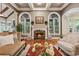 Cozy living room with a marble fireplace, large windows, and hardwood floors at 2551 Raintree Ne Dr, Atlanta, GA 30345