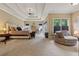 Spacious main bedroom boasts tray ceilings, sitting area, and plush carpeting at 2551 Raintree Ne Dr, Atlanta, GA 30345