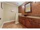 Stylish powder room featuring granite countertops, a vessel sink, tiled accent wall, and tile flooring at 2551 Raintree Ne Dr, Atlanta, GA 30345