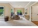 Cozy sitting area with natural light, neutral colors, and plush chair near the windows at 2551 Raintree Ne Dr, Atlanta, GA 30345