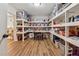 Spacious storage room featuring custom shelves and laminate wood flooring at 2551 Raintree Ne Dr, Atlanta, GA 30345