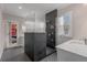 This bathroom showcases a black tiled shower with a glass surround, double showerhead, and a separate vanity at 4020 Declaration Dr, Roswell, GA 30076