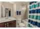 Bright bathroom featuring a shower-tub combo and vanity with dark wood cabinets and white countertop at 4020 Declaration Dr, Roswell, GA 30076