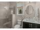Modern bathroom featuring a glass-enclosed shower, marble vanity, and contemporary fixtures at 4020 Declaration Dr, Roswell, GA 30076