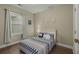 This bedroom offers a large window for light, neutral paint, and hardwood floors at 4020 Declaration Dr, Roswell, GA 30076