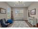 Bedroom with a large window, a blue accent rug, and modern decor at 4020 Declaration Dr, Roswell, GA 30076