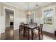 Elegant dining room featuring wainscoting, a modern chandelier, and large windows at 4020 Declaration Dr, Roswell, GA 30076