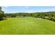 Expansive dog park surrounded by a black fence with several seating areas and plenty of space for pets to roam at 4020 Declaration Dr, Roswell, GA 30076